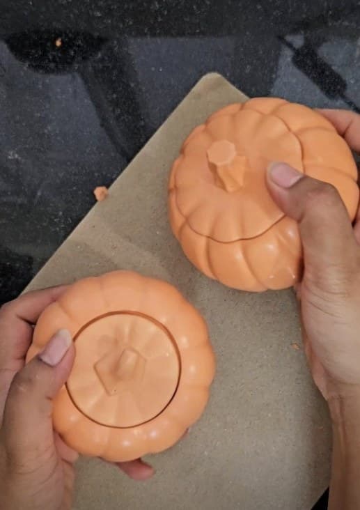 Two peach pumpkin-shaped lidded jars
