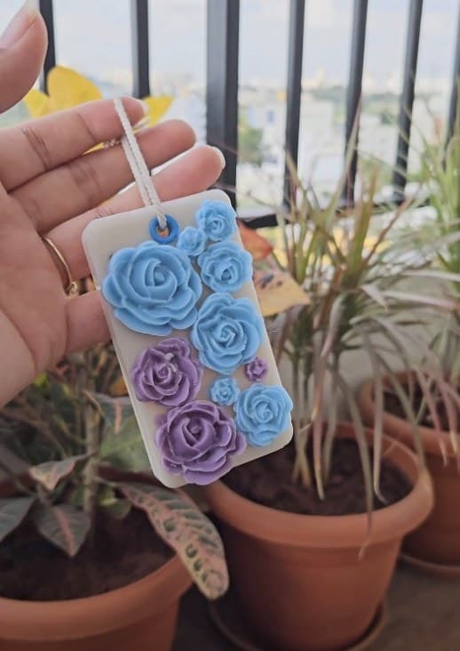 Scented wax sachet decorated with blue and purple wax roses